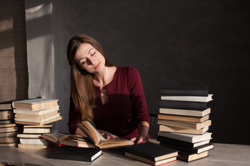 girl reading book prepares for the exam in the library