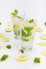 close up view of refreshing citrus lemonades with mint leaves isolated on white