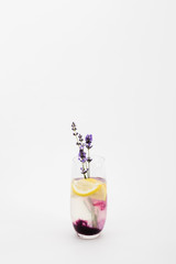 refreshing homemade lemonade with lavender and lemon pieces in glass isolated on white