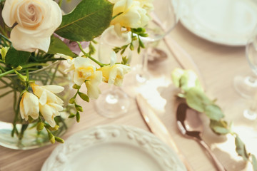 Beautiful composition with fresh freesia in vase on table