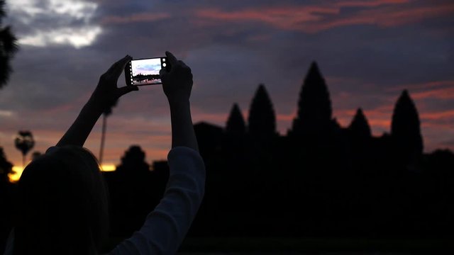 Tourist Woman Taking Photos With Phone Of Angkor Wat Temple At Sunrise. Siem Reap, Cambodia. HD, 1920x1080. 