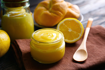 Beautiful composition with delicious lemon curd on wooden table