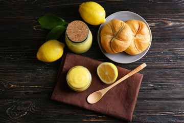 Beautiful composition with delicious lemon curd on wooden table