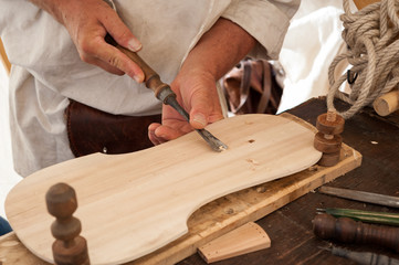 The luthier builds a medieval stringed instrument