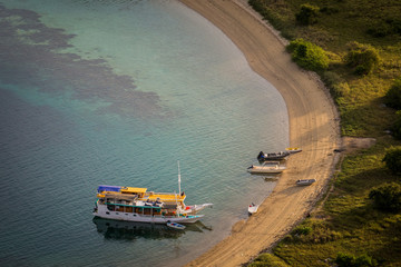 Tourist boats are parking at the empty beach.