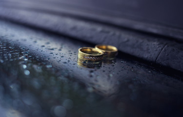 Wedding rings with jewel stones on a blue background