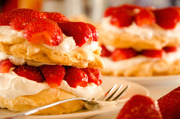 Homemade cream layer cake, fresh, colorful, and delicious dessert with juicy strawberries, sweet whipped cream and cream cheese