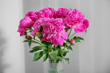 Bouquet of beautiful peony flowers on light background
