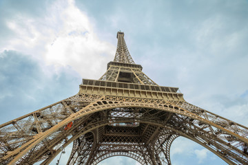 Fototapeta na wymiar Prospective view of Tour Eiffel, symbol and icon of Paris. Bottom view of Eiffel Tower in the sky, Paris, France, Europe.