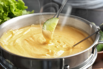 Slice of cucumber and cheese fondue, closeup