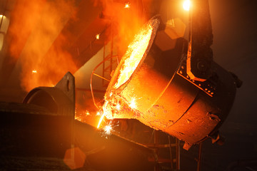 Pouring molten steel in the foundry