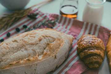 Fresh fragrant bread on the table, fresh bread and baked goods on wooden chopping board, rustic style, Food concept