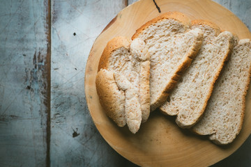 Fresh fragrant bread on the table, fresh bread and baked goods on wooden chopping board, rustic style, Food concept
