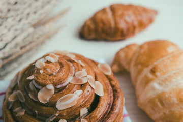 fresh bread and baked goods on wooden chopping board, rustic style