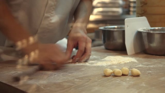 Chinese chef preparing food in kitchen