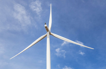 wind turbine generating electricity producing alternative energy with blue sky background