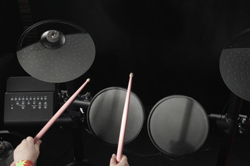 Unidentified Caucasian little girl play electronic drum