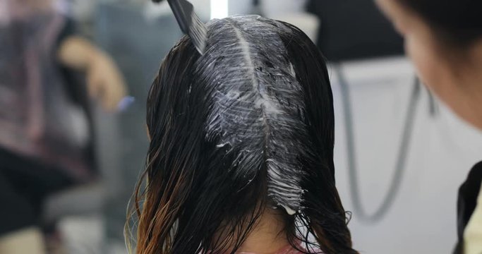 Woman in gloves is dying hair. hair dyeing. Beauty making, people in barbershop salon concept