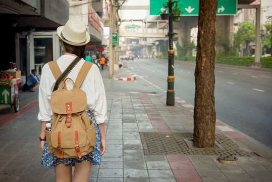 Happy asain girl walking on bangkok street