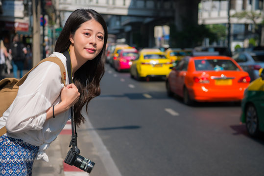 Woman waiting taxi on the road. Asian woman