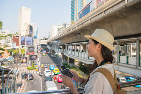 Traveler woman using tablet on flyover