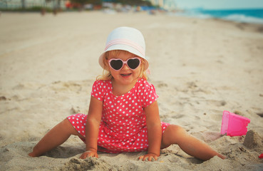 cute little girl play on beach