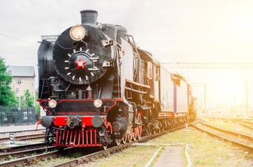 Vintage black steam locomotive train rush railway station