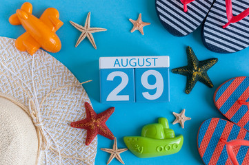 August 29th. Image of August 29 calendar with summer beach accessories and traveler outfit on background. Summer day, Vacation concept