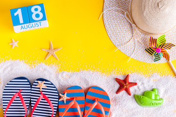 August 18th. Image of august 18 calendar with summer beach accessories and traveler outfit on background. Summer day, Vacation concept