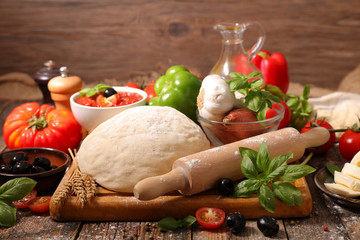 raw dough pizza with ingredients