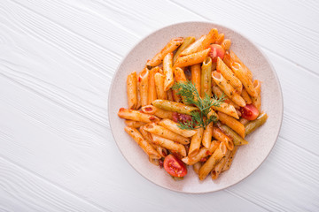 delicious penne pasta on wood white table