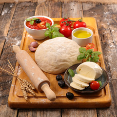 raw dough pizza with ingredients