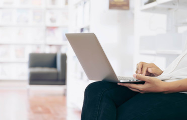 Fototapeta premium Southest Asian Business Woman Working on Labtop in a Library at Office Building