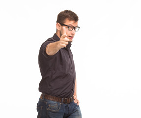 Fototapeta premium Young confident man portrait of a confident businessman showing presentation, pointing paper placard gray background. Ideal for banners, registration forms, presentation, landings, presenting concept.