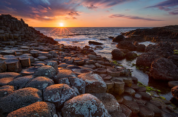 sunset over basalt columns Giant's Causeway known as UNESCO World Heritage Site, County Antrim,...