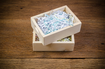 shredded paper in wooden box