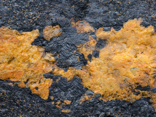 Texture of natural stone with a pattern of black and orange.
