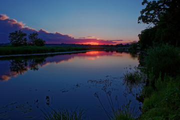 Naklejka na ściany i meble Sunset over the River in July.