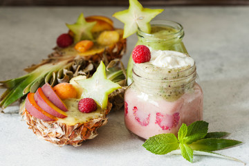 Layered berry and chia seeds smoothies and exotic fruit salad