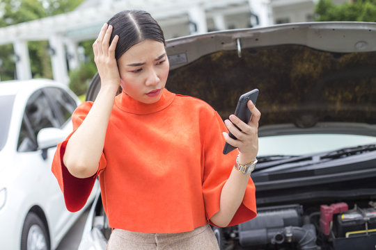 Young Asian Woman feeling Stressed when Car Defect Engine breakdown