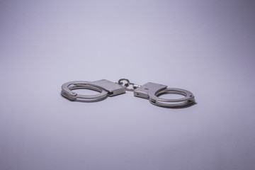 Photo of a pair of handcuffs isolated on a white background