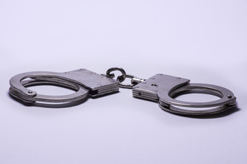 Photo of a pair of handcuffs isolated on a white background