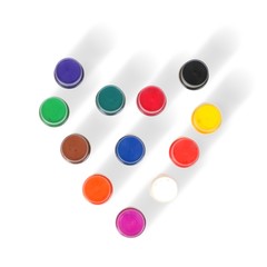 Acrylic colors on a white background in jars arranged in the form of a heart