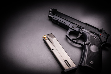  9mm pistol gun on black background