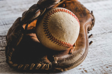 old Baseball and glove on wood background with filter effect retro vintage style