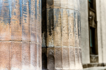 Closeup of old vintage columns of European style building wet from rain