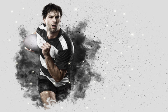 Rugby player coming out of a blast of smoke.
