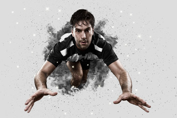 Fototapeta na wymiar Rugby player coming out of a blast of smoke.