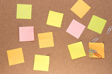 Fototapeta premium Multiple multi-coloured post it notes on a wooden background 