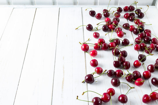 sour cherries on white wooden table,